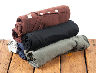 Rolled T Shirts on wood background