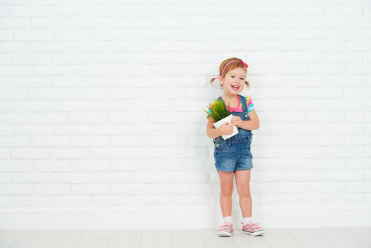 Happy Child Girl Laughing And Holding Pot With Potted Plant Near