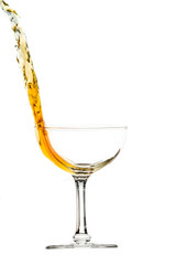 elegant  glass with splash of drink, amber colored liquid