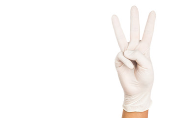 Hand in surgical latex glove gesture number Three.