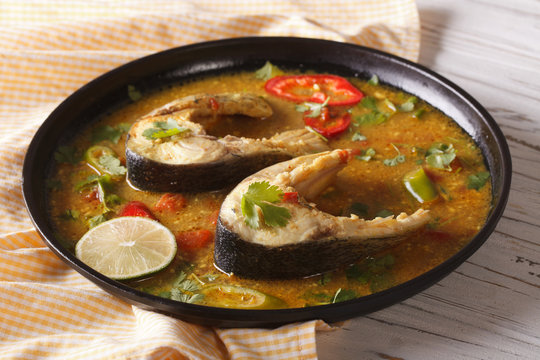 Indian fish curry with vegetables close-up. horizontal
