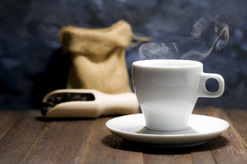 Still life of hot espresso coffee in white cup