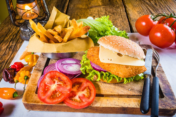 Set dish Chicken burger with fresh vegetables and fried chips