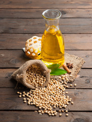 Soy bean and soy oil on wooden,Selective focus with shallow dept © showcake