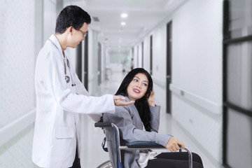 Fototapeta premium Doctor talking with disabled patient in hospital