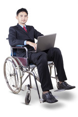 Handicapped businessman using laptop