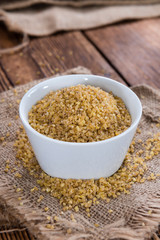 Raw Bulgur (on wooden background)
