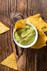 Some Nachos (with Guacamole) on wood