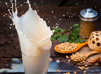 Soy milk splash with beans on wood