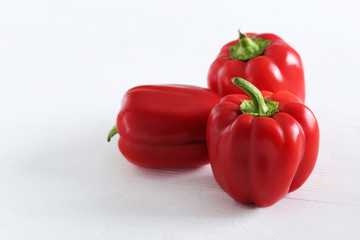 Red peppers on a white wooden background