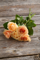 Bouquet of orange roses on grey wooden background