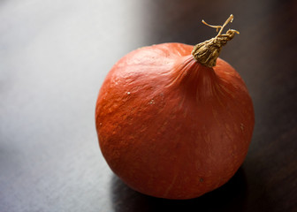 Pumpkin against dark wooden background for copy space