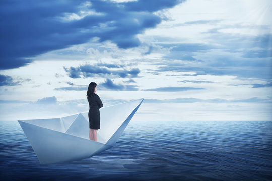 Asian Business Woman Standing On The Paper Boat