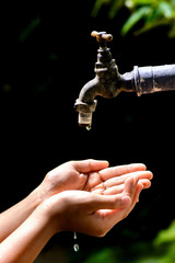 Little hand wait for water drop from faucet