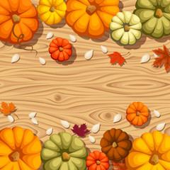 Pumpkins on a wooden background. Vector seamless background.