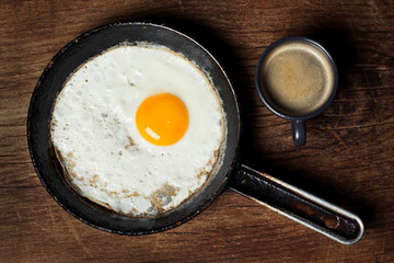 Breakfast setting with coffee and fried egg