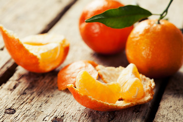 Open tangerine on wooden background