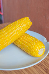 Boiled corn on white bowl