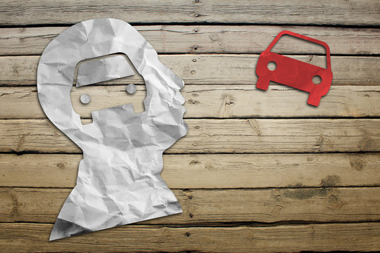 Paper humans head with car symbol