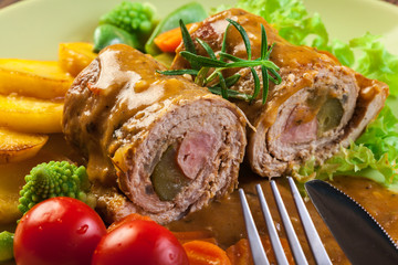 Pork rolls with prepared potatoes and vegetables