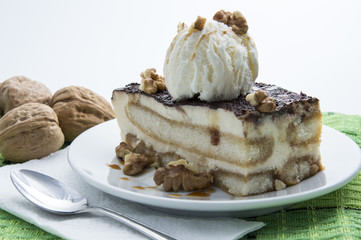 Tiramisu with vanilla ice cream and walnuts isolated on white background