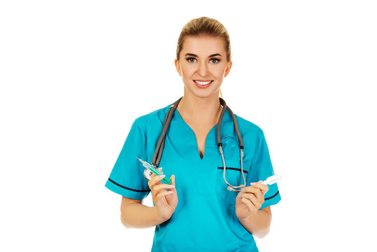 Female nurse or doctor preparing an injection