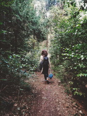 Naklejka na ściany i meble Girl walks in deep forest, tourist.