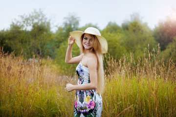 Beauty  women  in a straw hat alone with nature, freedom