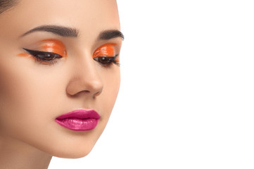 High fashion look, closeup beauty portrait of beautiful young woman model with bright makeup, perfect clean skin and colorful red pink lips and orange eyeshadow. 