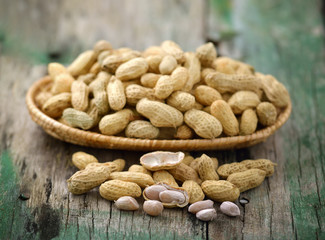  peanuts in the  basket on wooden