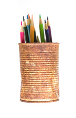 color pencils in rusty tin can, wood table