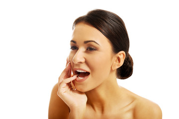 Happy beautiful woman holding finger in mouth