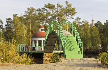 The bridge and gazebo in autumn city park.