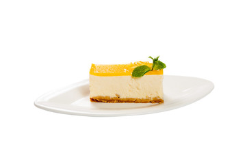 Lemon tart on a plate with fresh mint leaf