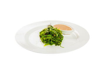 Seaweed salad with the dressing on the plate