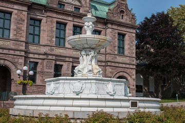 Fototapeta na wymiar Fulford Fountain in front of The Former Brockville (Thomas Fuller) Post Office Building Ontario Canada