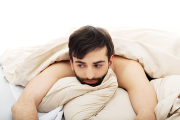 Man waking up in bedroom.
