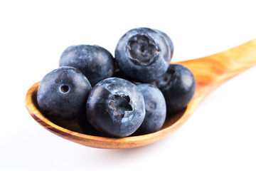 Fresh blueberries in wooden spoon