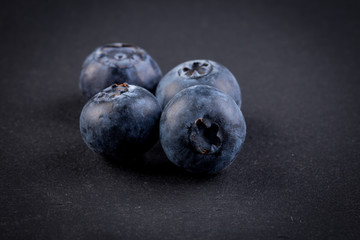 Blueberries on stone plate background