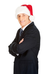 Side view man with folded arms wearing santa hat