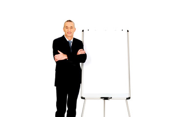 Male executive standing near flip chart