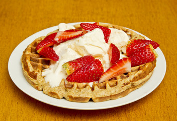 Waffle with strawberries and ice cream