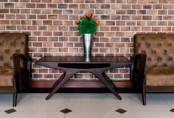 Fake flowers on a brown sofa.