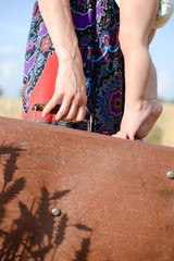 Mother and toddler with retro suitcase ready for traveling