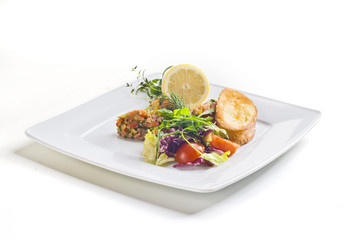 Salmon salad with vegetables and baguette on white background 