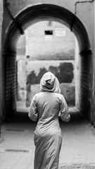 traditionally clothed arabic woman walking in the medina of marr