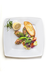 Salmon salad with vegetables and baguette on white background 