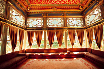 Turkish sofas and colorful ceiling in traditional Ottoman room of the 15th century Topkapi Palace in Istanbul © radiokafka