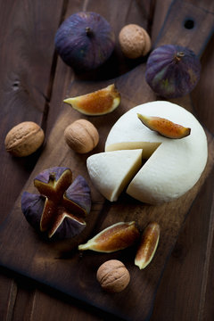 Adygea cheese with fresh fig fruits and walnuts, studio shot