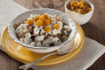 Cottage cheese with cloudberries and cereal flakes  .